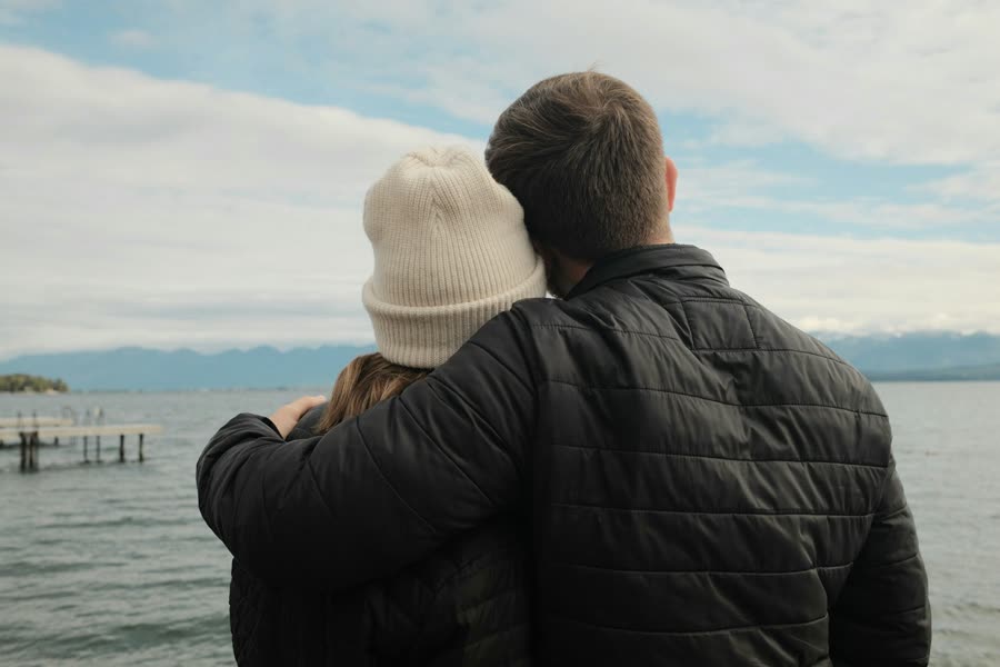 A couple looking out over a lake